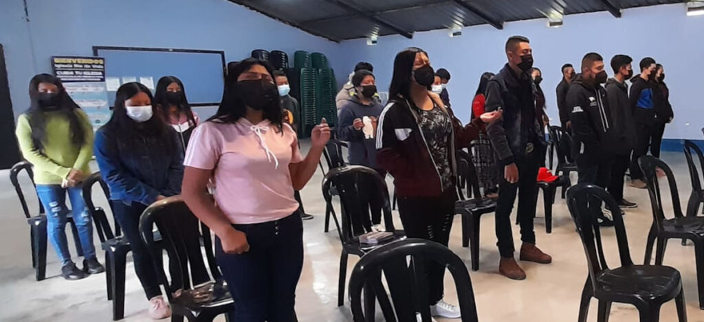 Weekend Extension Program students worshipping during devotional