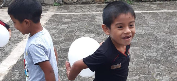 Juan and a classmate playing at school